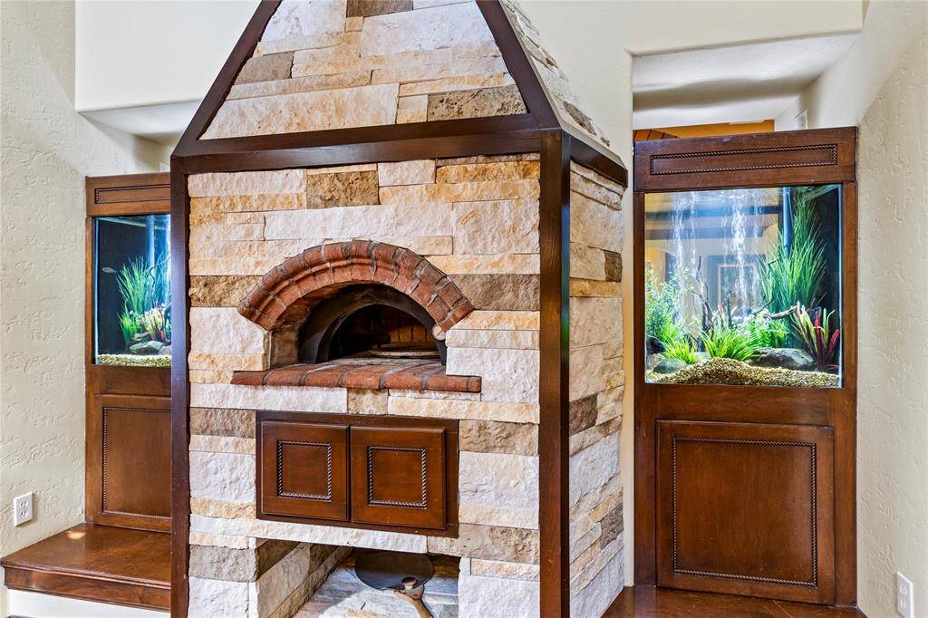 Beautiful double sided fish tanks encompass the brick oven pizza cooker. A focal point of kitchen and living areas.