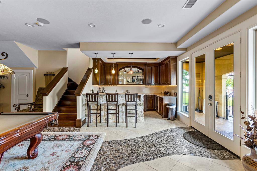 The game room is located on the 1st floor. French door provide easy access to the pool and patio area.
