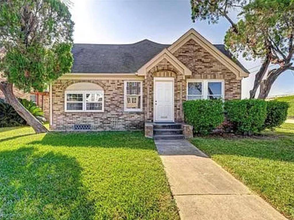 Charming brick home with a pitched roof and a welcoming front entrance. The property features a well-maintained lawn, mature trees, and a paved walkway leading to the front door. Ideal for those seeking a cozy, inviting exterior.