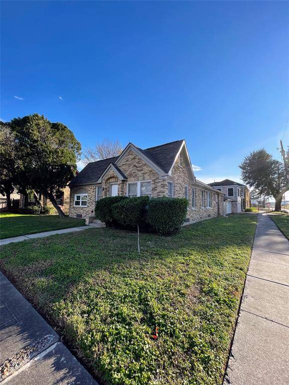 2204 Barbee is situated on a corner lot with mature trees, offering a welcoming curb appeal.