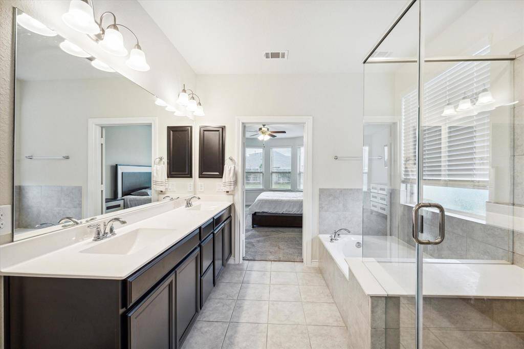 From the moment you enter this bath, you're drawn to the wonderful soaking tub. The splash proof separate shower stall is tiled all the way up to the top of the glass enclosure for easy upkeep.