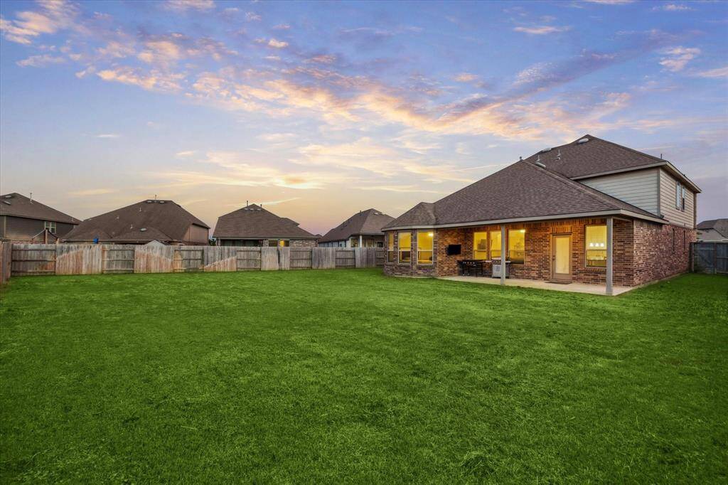 View of the rear yard at twilight.  You will agree, you have an incredible yard to have fun and delight in.