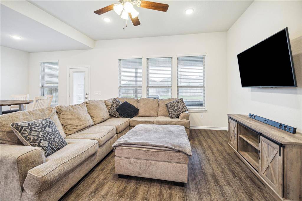 This wonderful gathering room / family room designed for informal gatherings has a high ceiling and tile plank flooring that is made to look like wood and very durable.