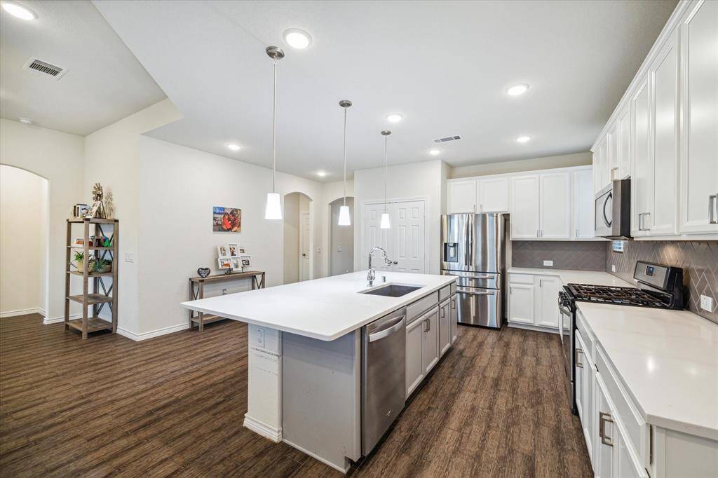 Warm and welcoming with something good on the stove.  It is the area everyone will head for when they come home.