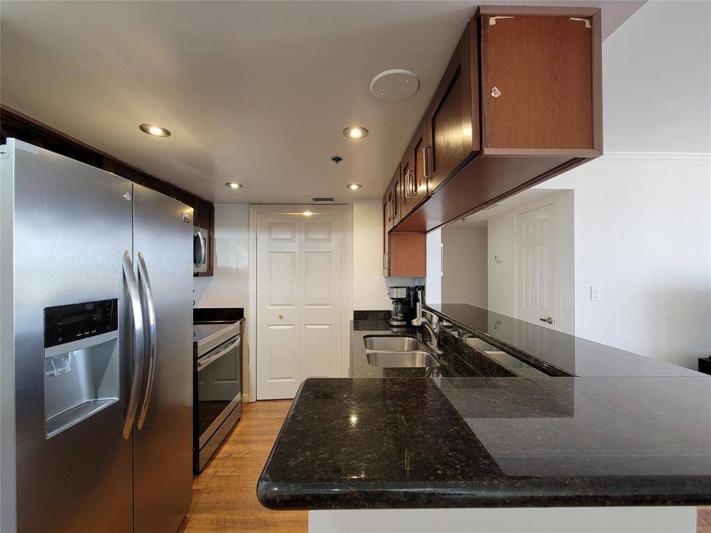 Stainless steel appliances, granite countertops, and plenty of storage add to the appeal of this unit. The Kitchen  is bright, with recessed lighting. Bi-fold doors conceal the laundry and pantry area.