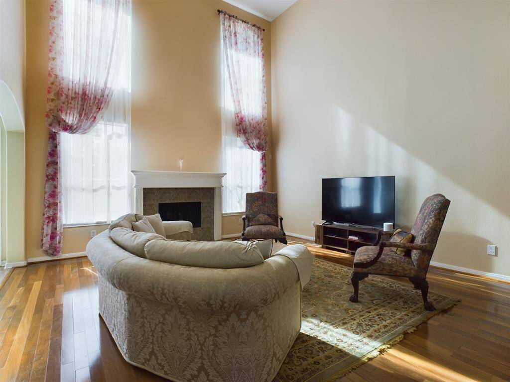 The living room features large windows that provide natural light and a fire place to create a cozy atmosphere