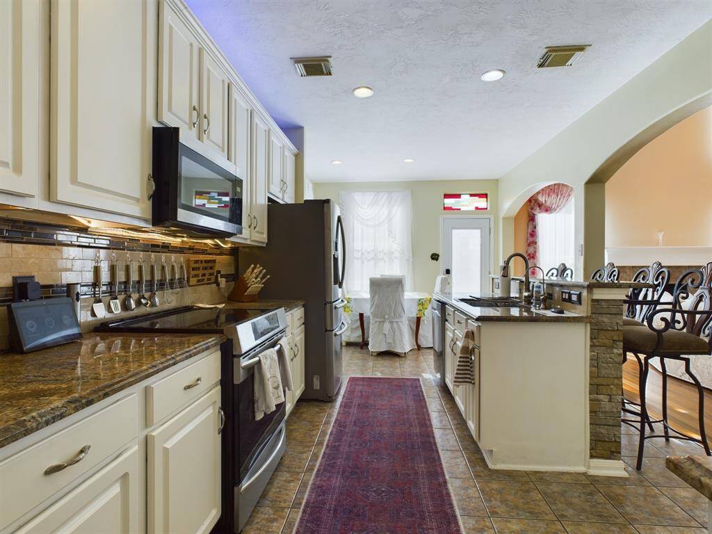 This kitchen features elegant cabinetry with ample storage