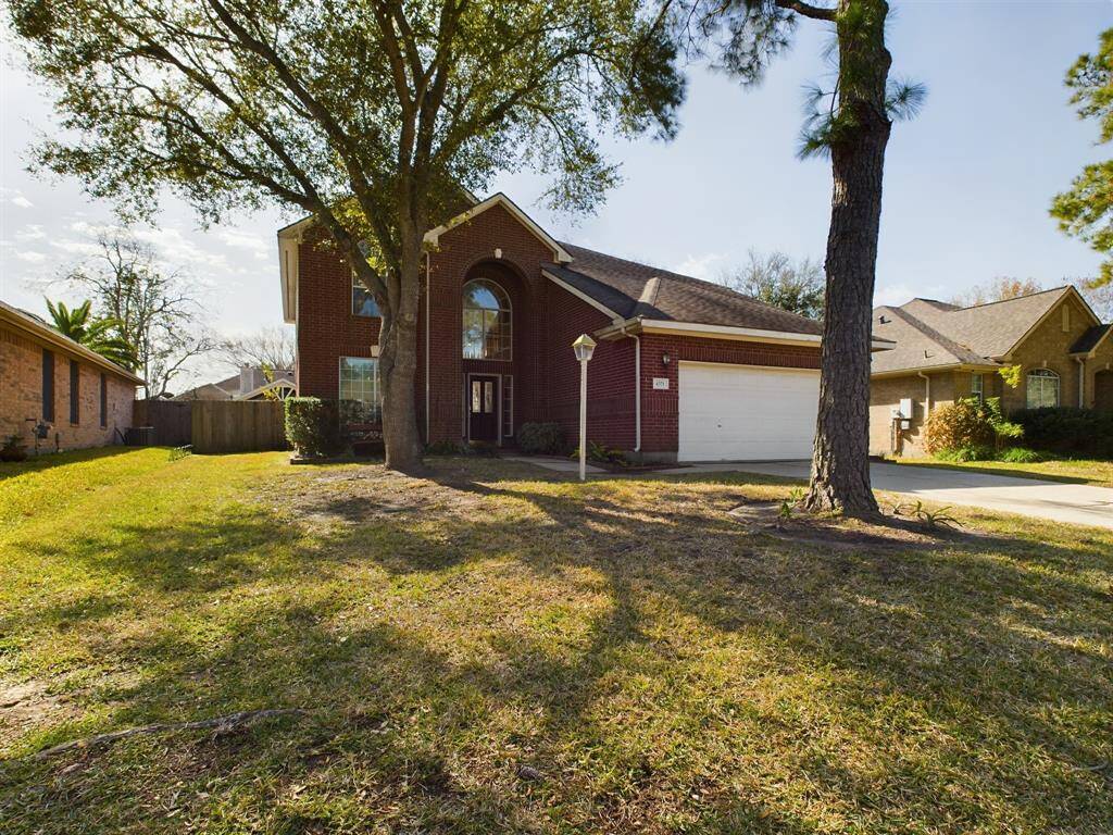 Complete with a spacious front yard and mature trees.