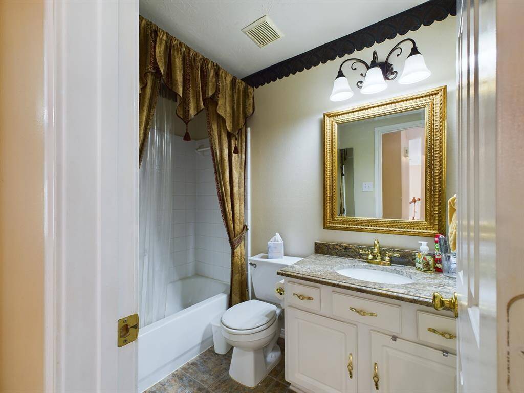 Secondary bathroom features a combination shower and tub.