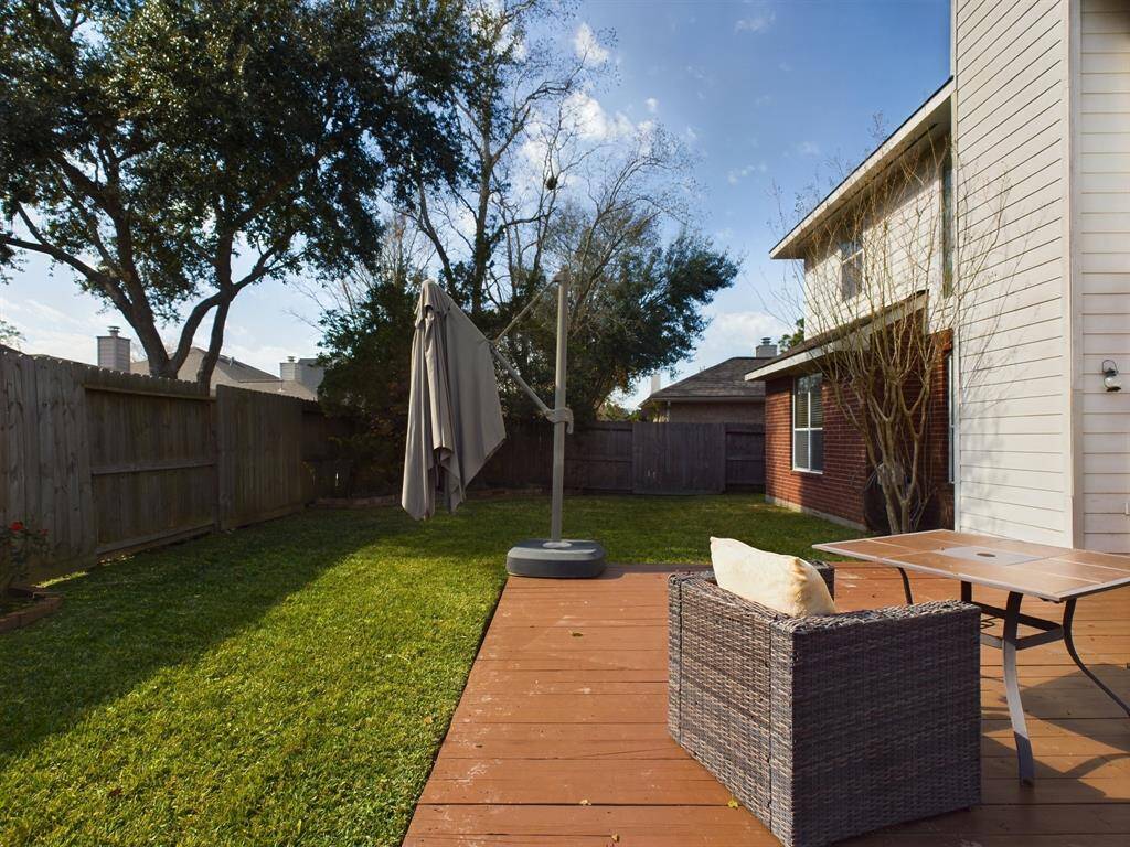 Cozy backyard with a wooden deck with endless possibilities