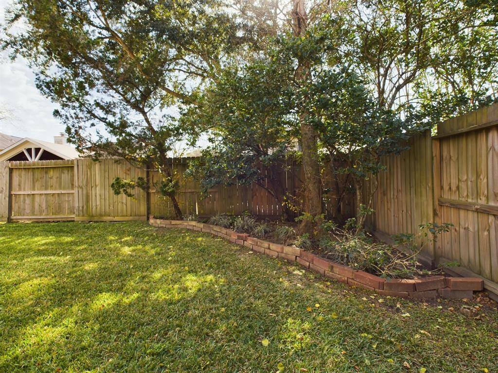 Charming backyard with mature trees that provide ample shade