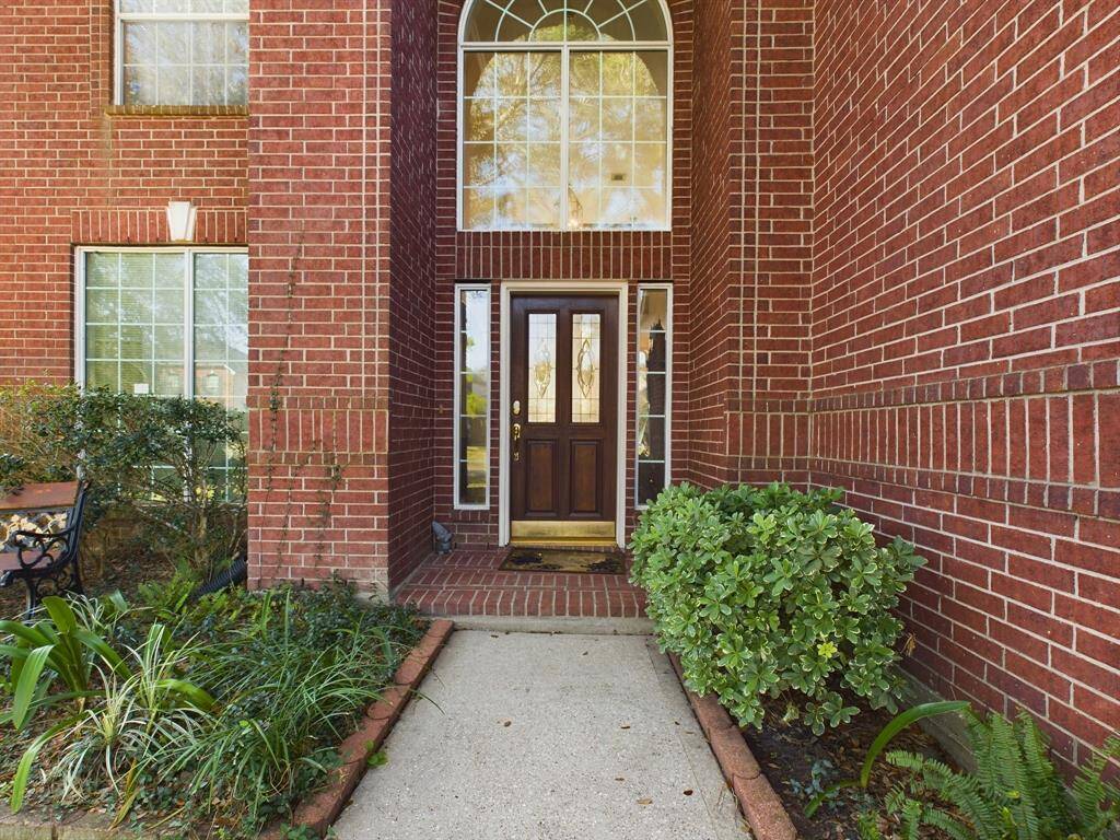 Welcoming front entrance of a home with a classic red brick exterior.