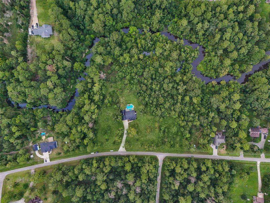 Property has ultimate Privacy with Trees and Creek as Borders. This shot includes all 8 .1 Acres. House being sold on 5.1 acres. An additional 3 acres are available.
