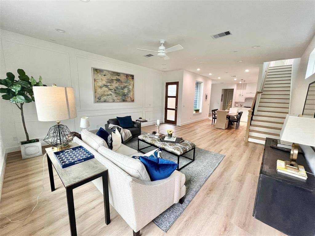 An open-concept home where elegant paneling, warm natural light, and seamless flow create the perfect harmony for modern living.