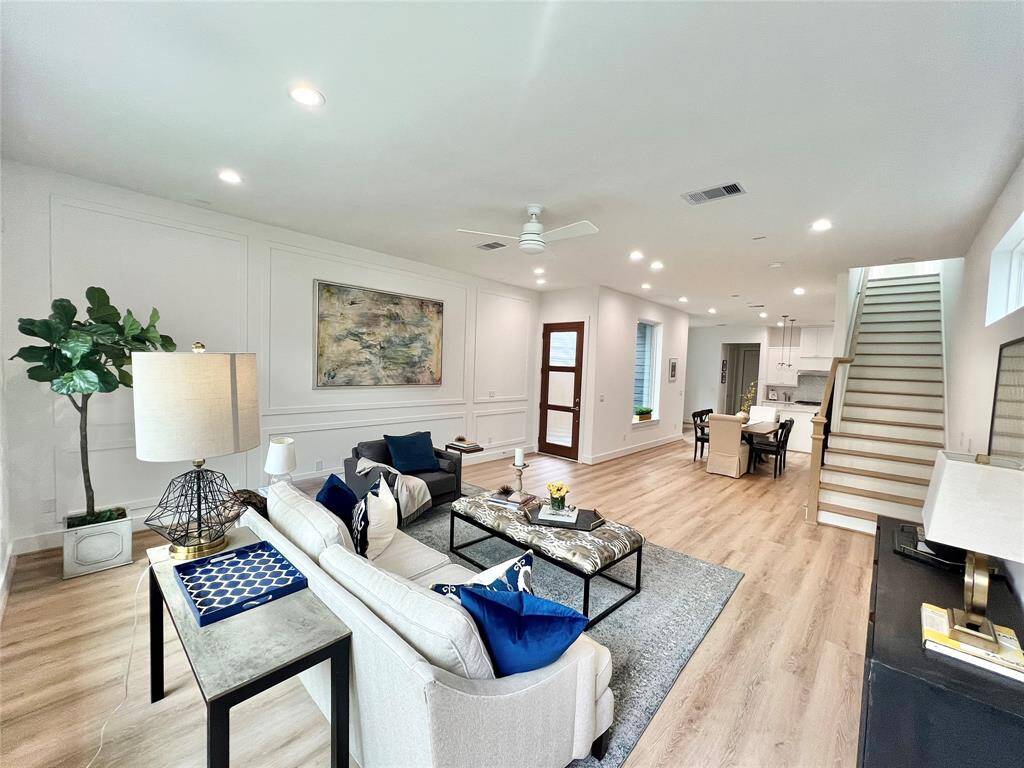 Elegantly appointed living room with striking vaulted ceilings and gorgeous flooring.