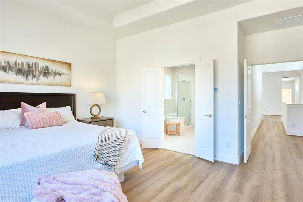 Exquisite design details and high-end finishes elevate this primary bedroom to a peaceful retreat.