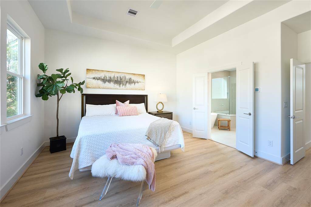 This spacious primary bedroom is the perfect combination of comfort, style, and sophistication.