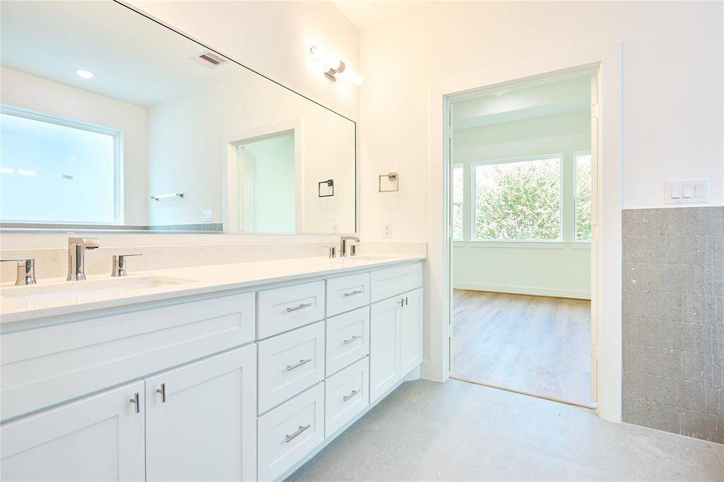 A stunning contrast of clean lines and intricate tile designs gives this bathroom a refined elegance.