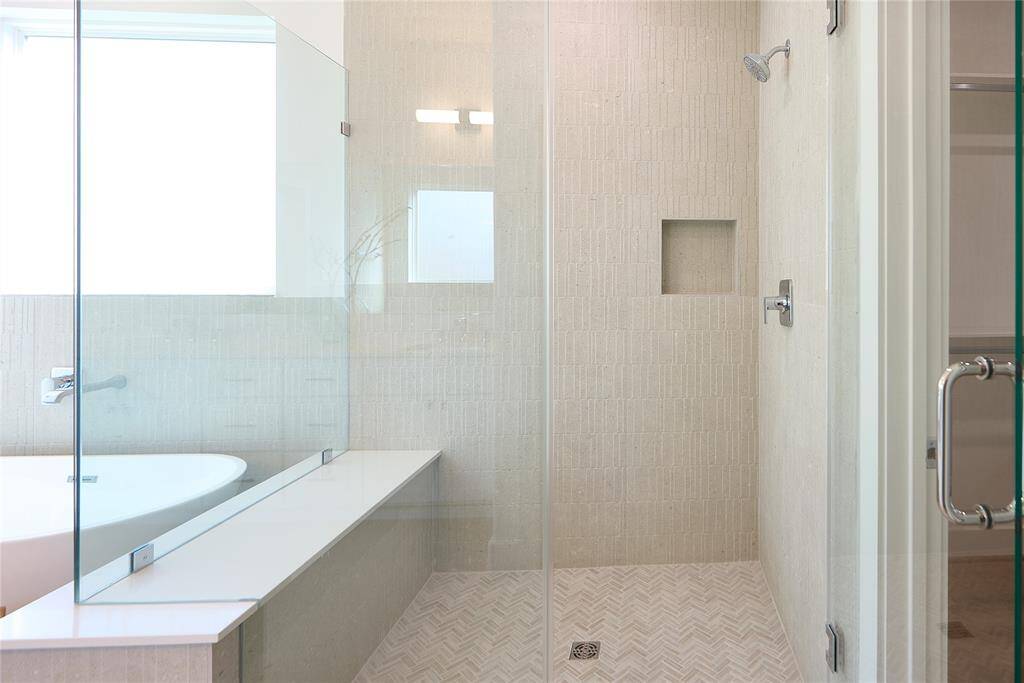 Oversized shower with frameless glass and designer tile.?