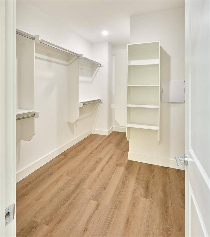 Expansive closet with custom shelving and storage solutions.?