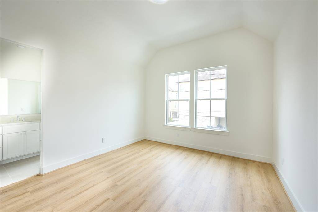 Comfortable guest room with high ceilings and large windows.?
