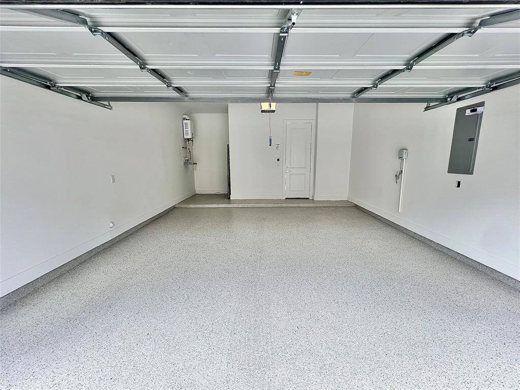 Spacious garage with epoxy shield flooring, ample storage, workspace.?