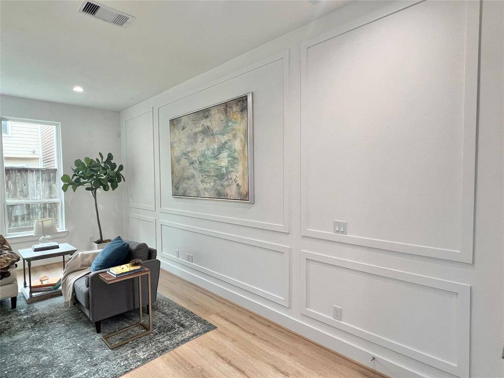Seamless wood paneling creates a curated backdrop for both modern and classic decor.