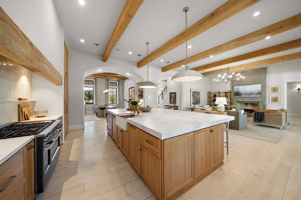 Open-concept kitchen, dining, and living area with modern rustic charm. Custom built cabinets throughout with upgraded Dekton countertops.
