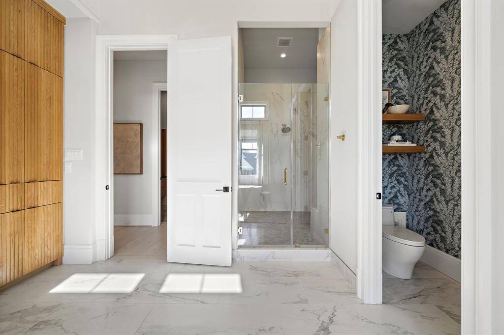 This bathroom also has a private lavatory and dedicated access to oversized walk-in shower.