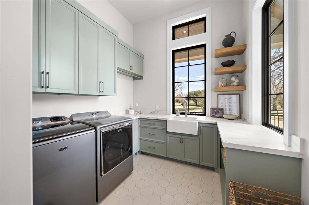 The downstairs laundry room has custom built cabinets throughout, floating shelves, and sink.  There is an additional space upstairs the current sellers have enclosed and use as an upstairs laundry room and heated/cooled storage space.  It is noted in the floorplan pdf which can be found in the attachments section.