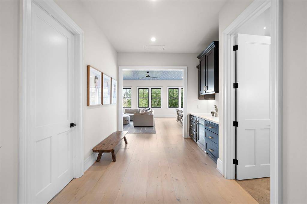 Greeting you at the top of the stairs is this oversized hallway with beverage fridge and built-in cabinets, drawers, and counter space perfect for game storage or snack display.
