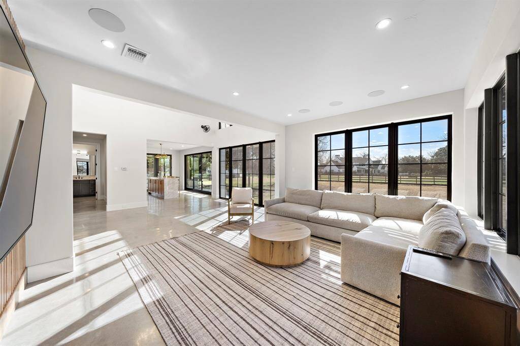 Great living room with added speakers throughout.  This view also shows the sliding patio doors off the Casita bar area, along with the hallway that accesses the dedicated kitchen and downstairs bathroom.  Just behind the wood wall and TV is a door to access a pet room with a dog door accessing the exterior dog run.  Ideal for when you're traveling and leaving pets behind.