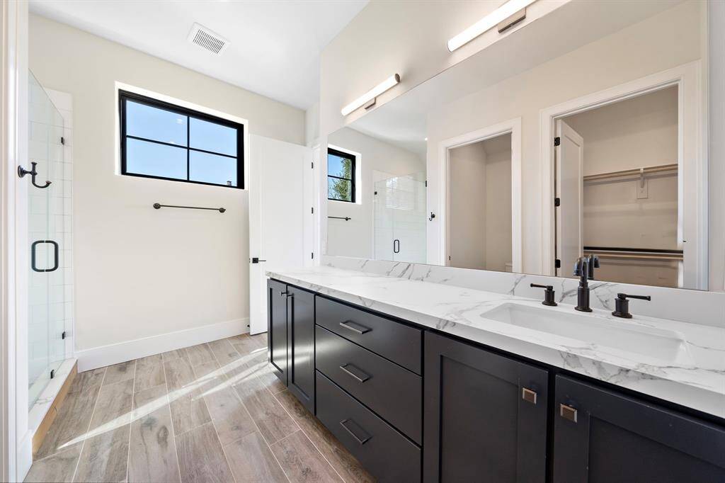 Upstairs private bathroom located just off the bedroom.  This space features a large walk-in shower, private lavatory, and walk-in closet.