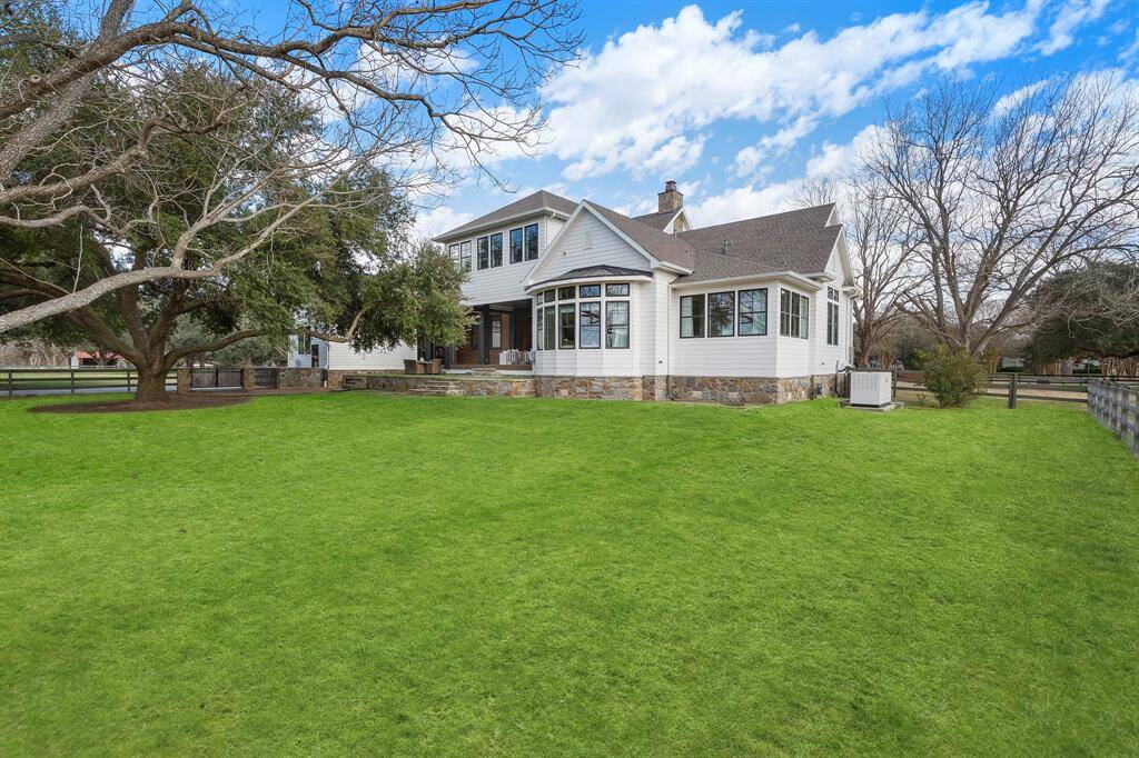 This home has appeal at all angles.  From the elevated back patio to the bay windows off the primary retreat.  Whole home generator is also shown.