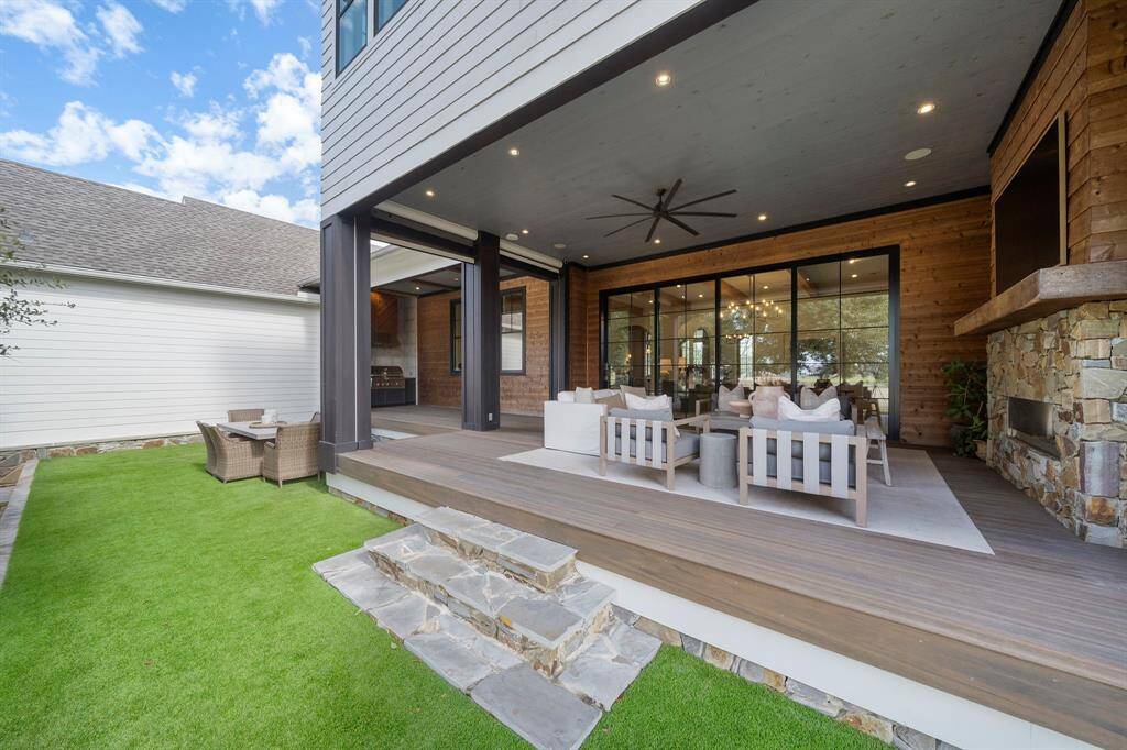 Outdoor living at its finest! A 60" Linear Outdoor Heatilator with multicolored LED lighting and remote-controlled roll down shades to enjoy the outdoors while watching your favorite sports or hosting events!