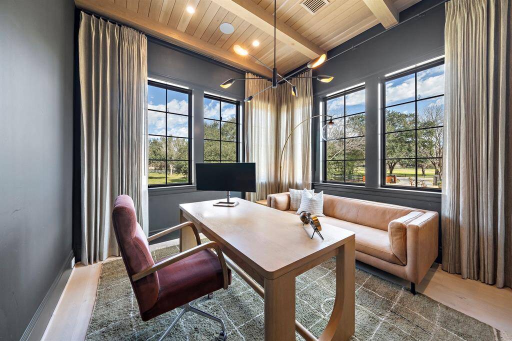 This home office features wrap around windows offering abundant natural light and scenic views.  This room can be used as a secondary guest bedroom as it has an en-suite bathroom and built-in wardrobe.