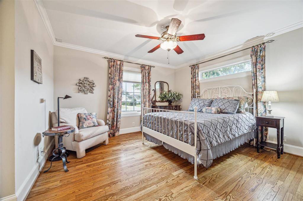 Bedroom 1 off the main hallway is large and overlooks the back yard. Crown molding is carried throughout the home