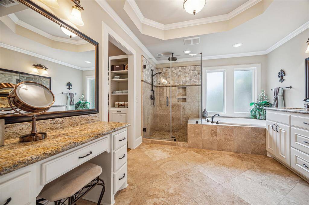 Primary bedroom was custom designed and added to the original home. The tray ceilings visually draw your attention to the size and natural lighting in this room. Patio access from the primary bedroom through the glass door (not pictured)