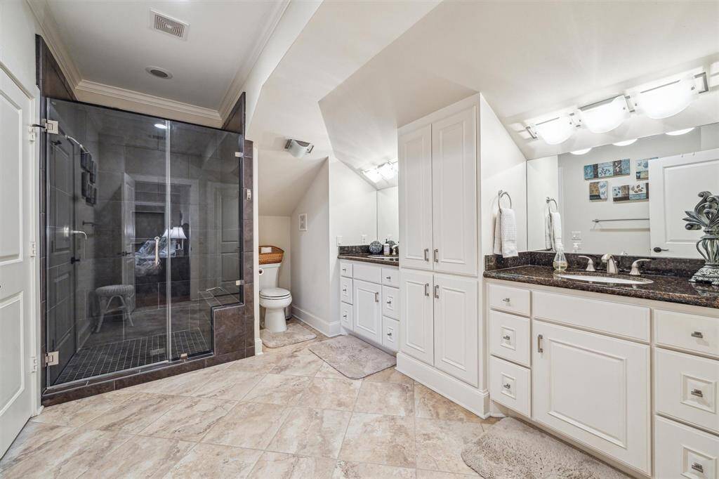 This closet has great use of space and was designed with function in mind. There's a pull out countertop to fold laundry, a full ironing board tucked way with it's own storage space, drawers to store your items and tons of room for hanging clothes.