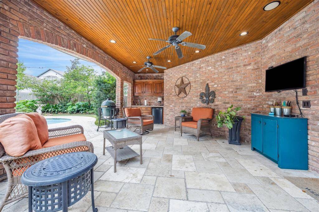 Wrought iron balcony railing overlooks an entertainers delight of a backyard and pool.