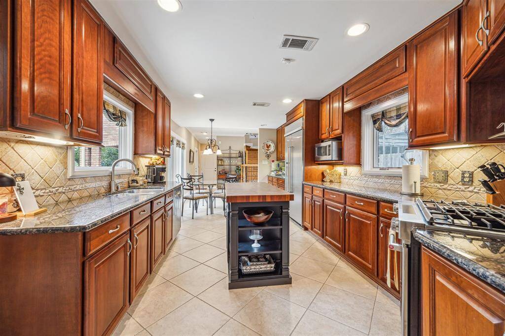 The dining room is large and open with beautiful wooden floors and wood wainscoting and is just off the kitchen
