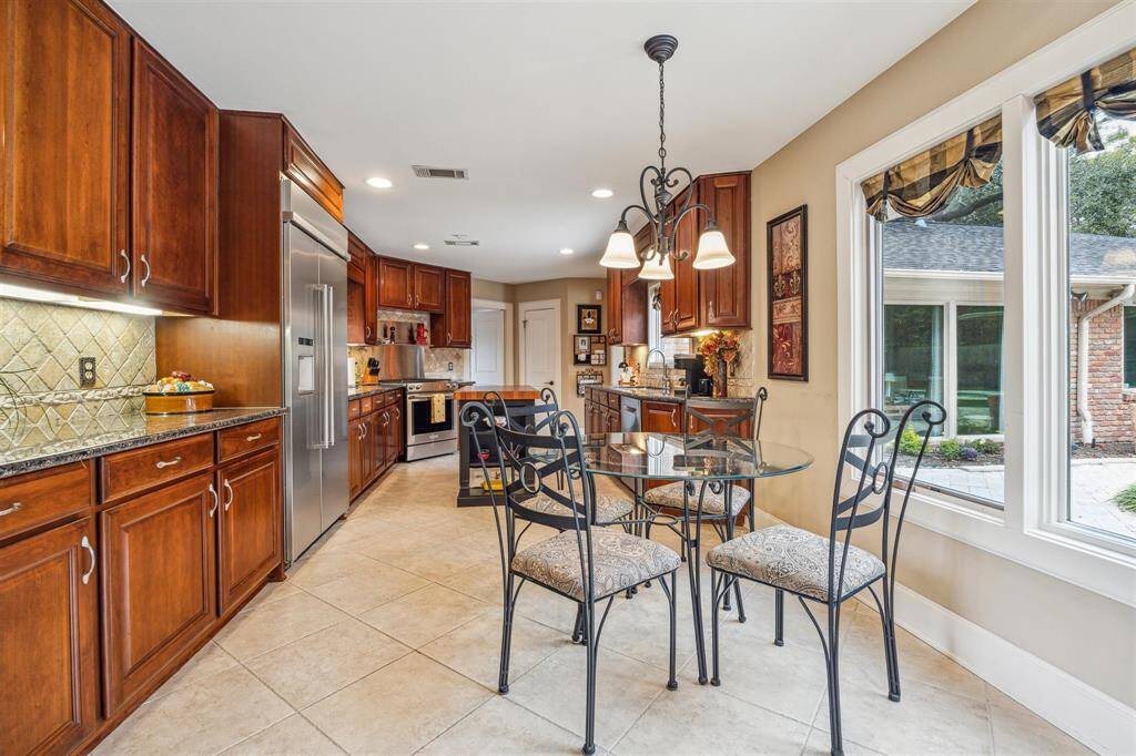 The kitchen has views of the backyard and the driveway. The center island is furniture and can stay with the home