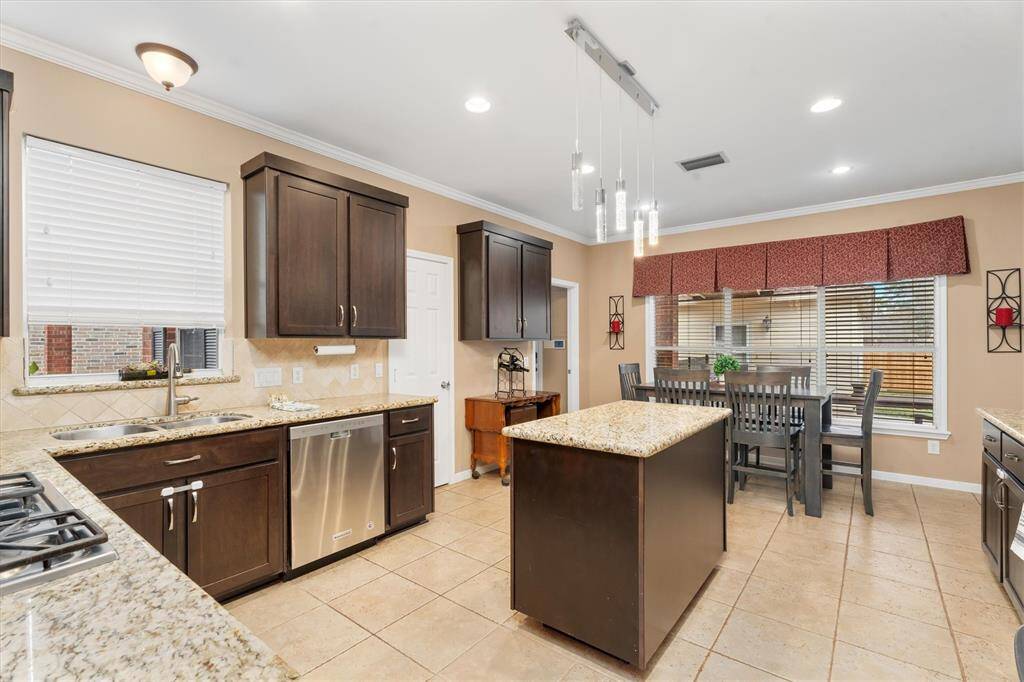 The bright kitchen with modern lighting will host your family gatherings! Everyone will love hanging out in this beautiful space!