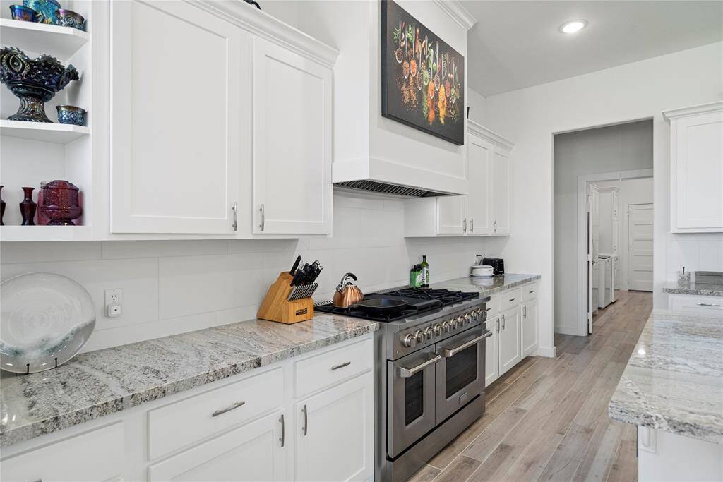 Last look at the kitchen showing the 6 burner gas cooktop and twin ovens.