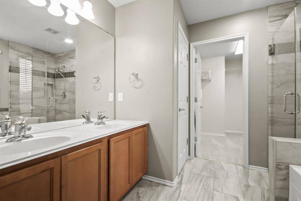 Updated primary bathroom with walk-in closet.