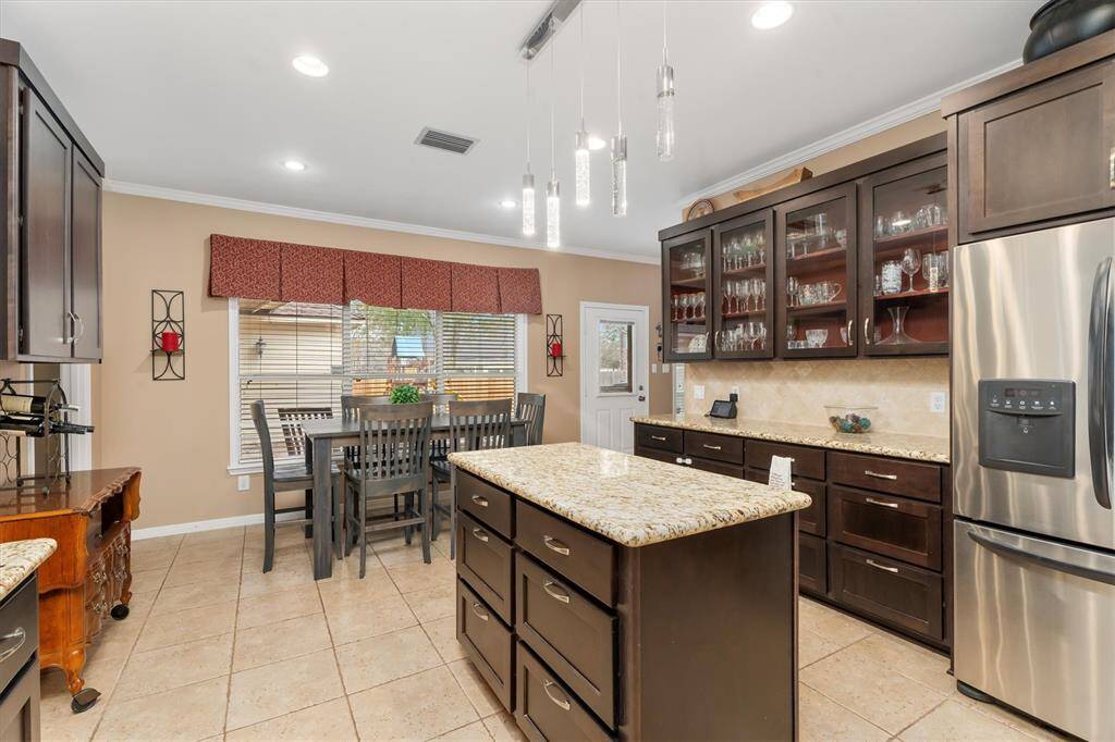 A double sized window provides a great view of the backyard from the breakfast room.