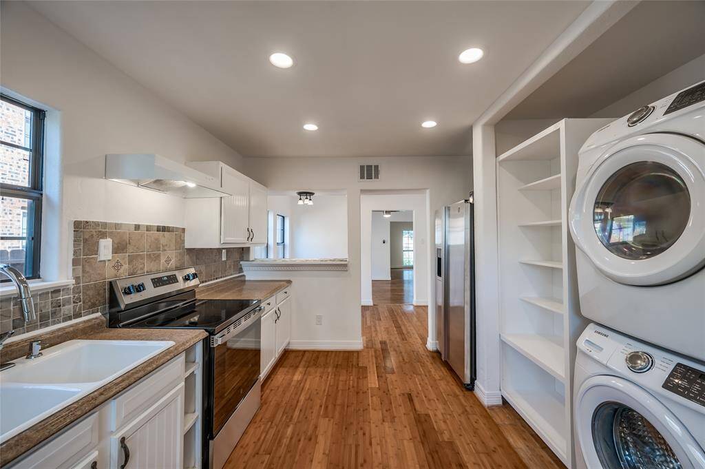 Spacious, light, warm finishes, great counter and storage space, along with a stackable washer and dryer.