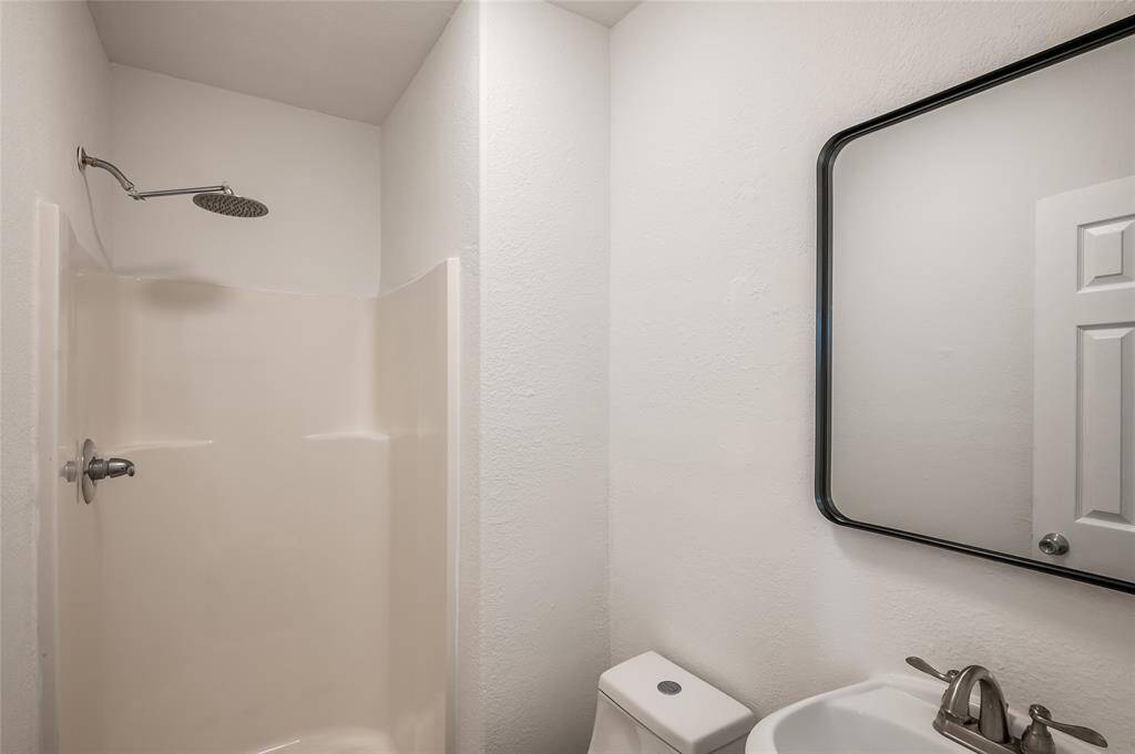 There is a second bath with shower, which is between the second bedroom and the home office.