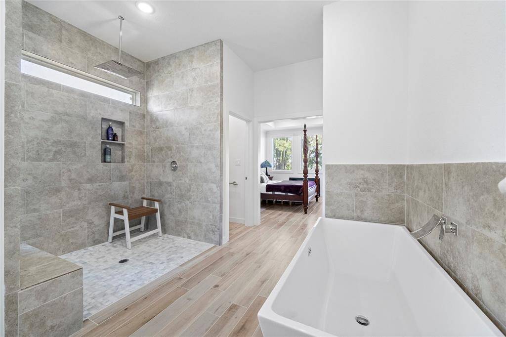 Primary bath has a large shower and soaking tub.