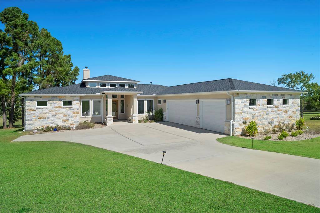 Very nice (almost new) single story stone and stucco home located on almost two acres with Lake Conroe access!